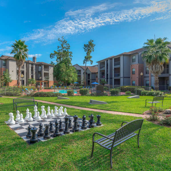 Exterior view of the building with a view of courtyard and chess plaza at Edgewater at Klein in Spring, Texas