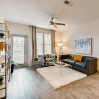 Modern furnishings in a model apartment's primary bedroom at Discovery at Craig Ranch in McKinney, Texas