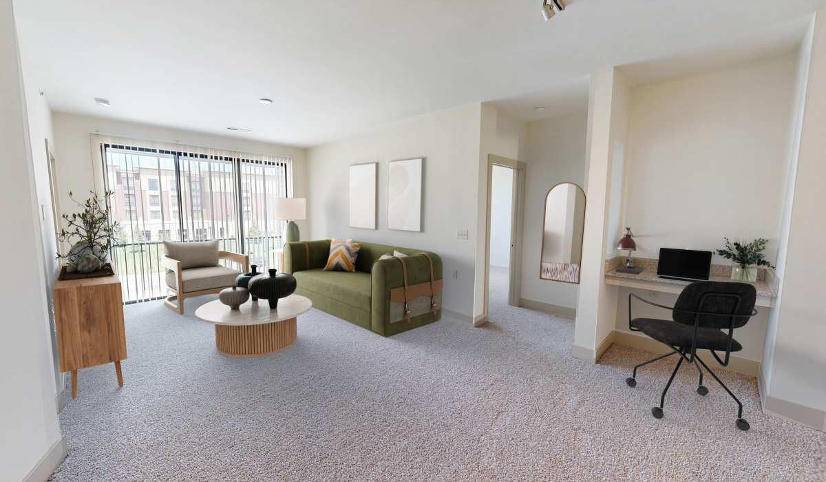 Spacious living room with couche and workspace at Latitude at Deerfield Crossing in Mason, Ohio