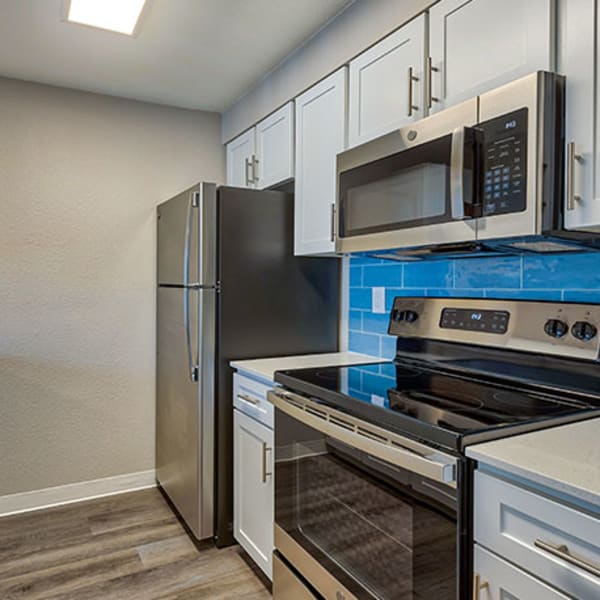 Modern kitchen with stainless-steel appliances at The Retreat at Bothell, Bothell, Washington