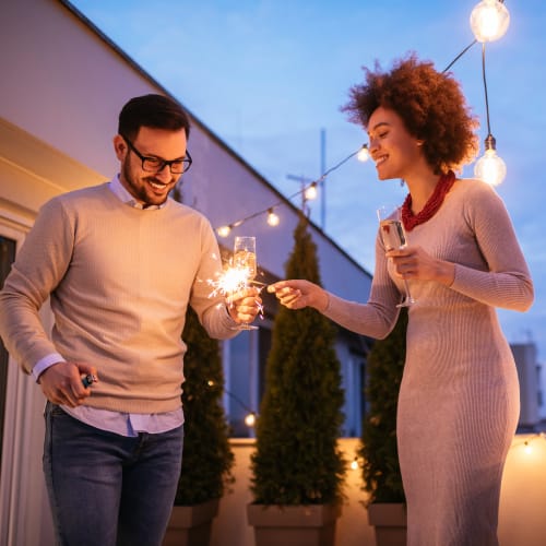 Couple celebrating on their private balcony at Solaire 8200 Dixon in Silver Spring, Maryland