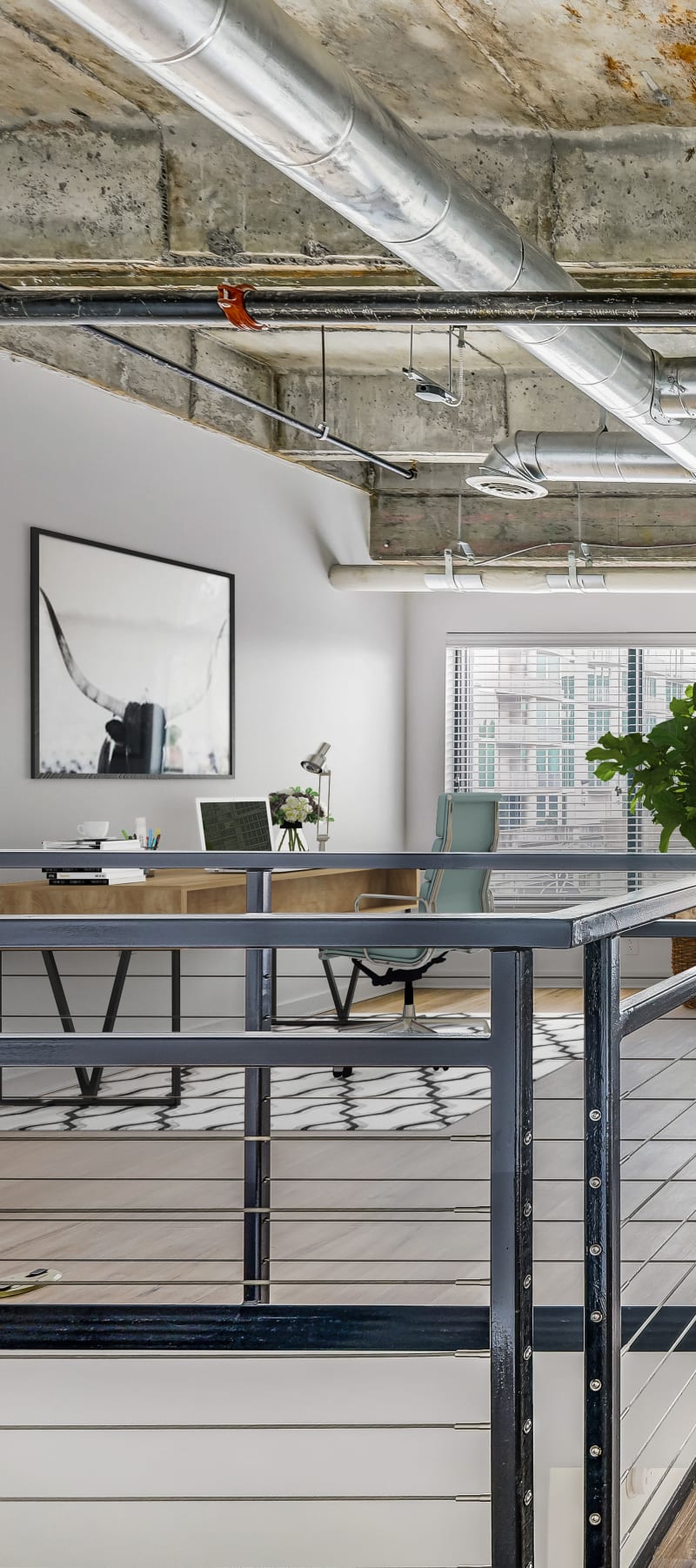 Robust home office setup on the mezzanine of a loft home at 17th Street Lofts in Atlanta, Georgia