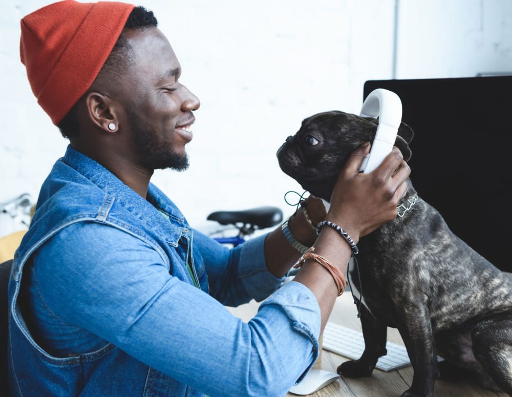 Future resident listening to music with his dog near UNCOMMON Fort Collins in Fort Collins, Colorado