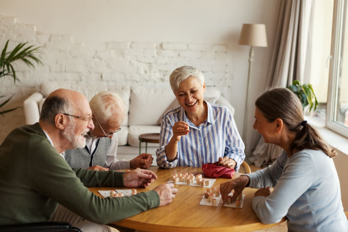 Residents having fun while playing a game at Oxford Vista Wichita in Wichita, Kansas