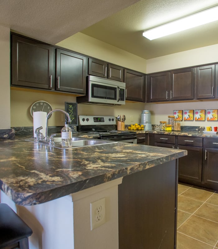 Kitchen with granite countertops at Mission Point Apartments in Moore, Oklahoma