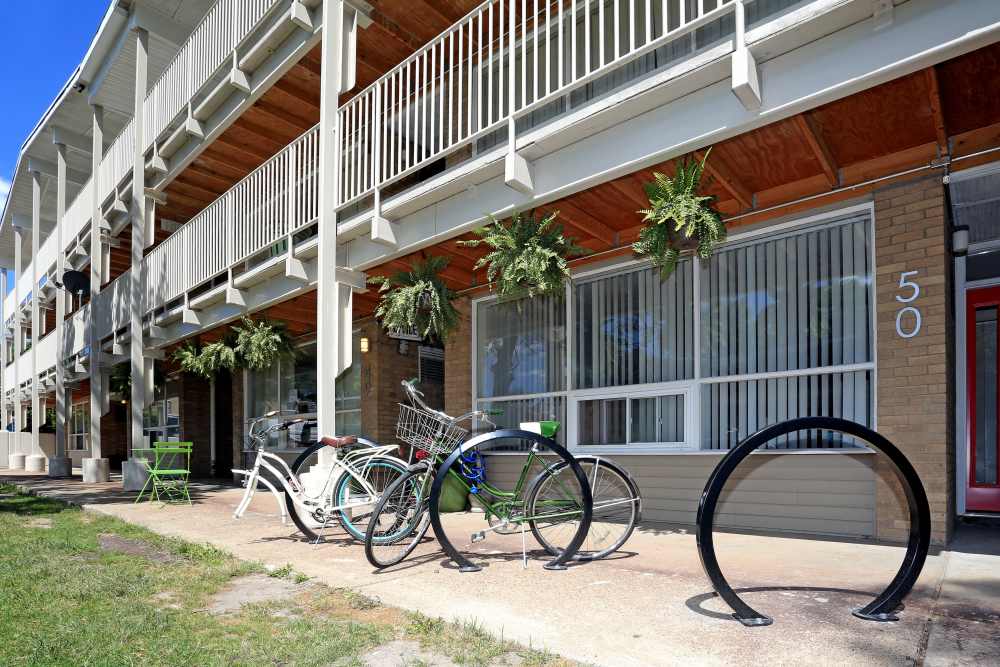 Exterior building with bicycle rack at Detroit Living in Detroit, Michigan