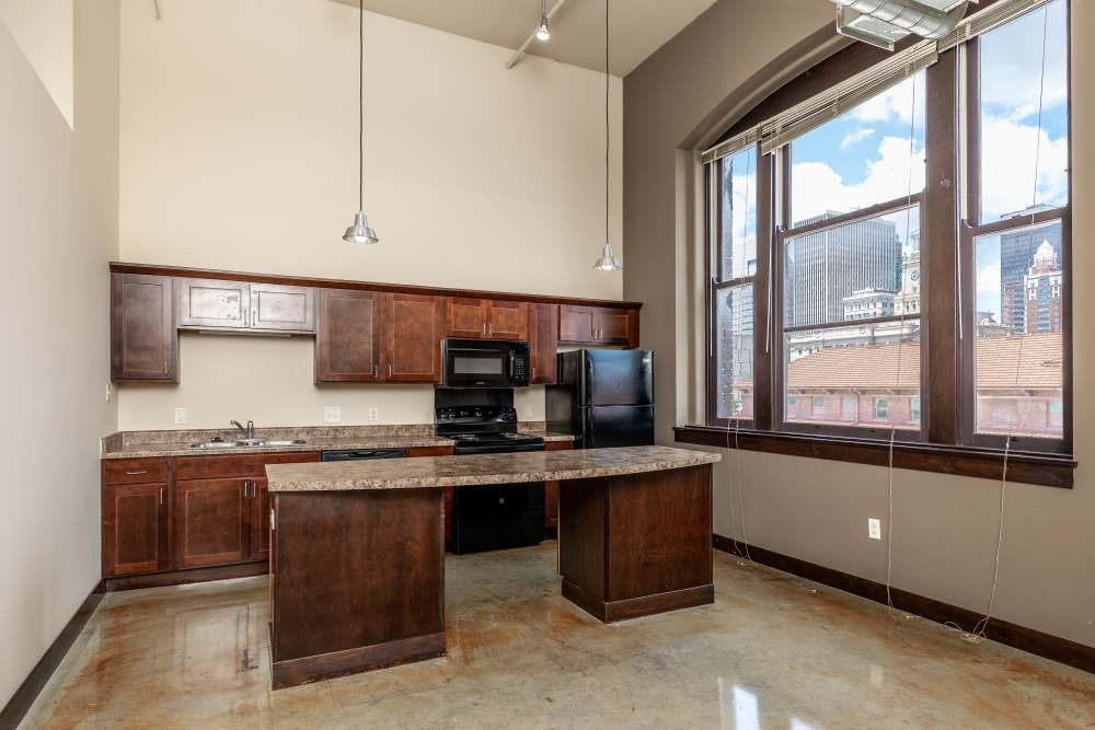 Brown cabinets with granite countertop at Rumely Lofts in Des Moines, Iowa
