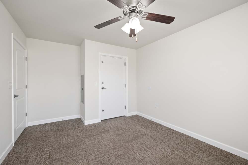 Bedroom with ceiling fan and carpet flooring at Harbor West Villas in Warsaw, Missouri