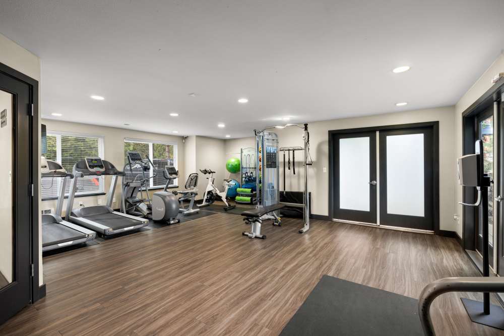 Fitness center with treadmill at Karbon Apartments in Newcastle, Washington