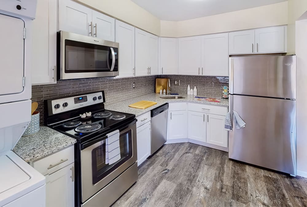 Kitchen with white cabinetry and stainless-steel appliances at Imperial Gardens Apartment Homes in Middletown, New York.