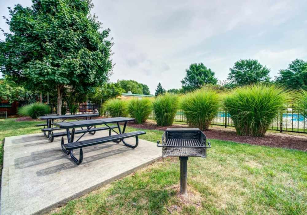 Grill area with seating at Courtyard Apartments in Columbia, Missouri