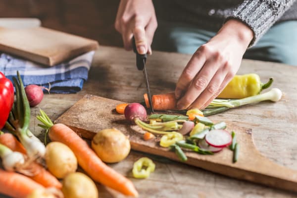 Resident chopping fresh veggies from the market near  Landmark Glenmont Station in Silver Spring, Maryland