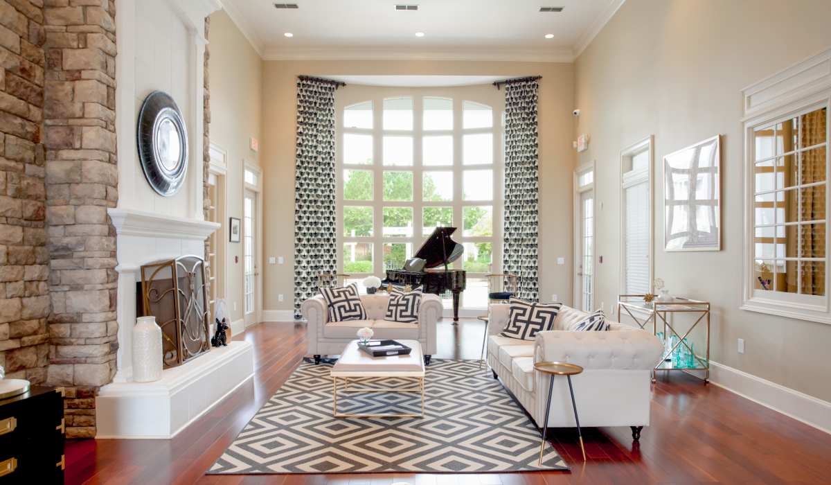 Interior of a community clubhouse with fireplace and couches at Madison Park in Madison, Alabama