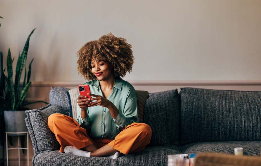 Resident using her phone at Artisan Living Mills River in Mills River, North Carolina
