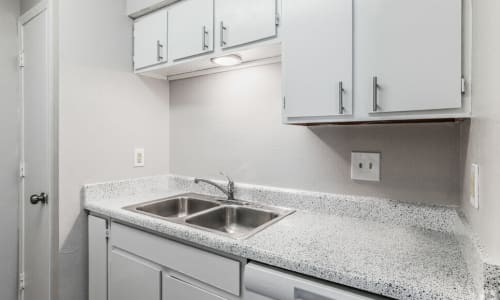 Kitchen with white cabinets and white appliances at Midwest City Depot in Midwest City, Oklahoma