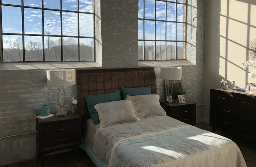 Tall windows in an apartment bedroom at Bellevue Mill in Hillsborough, North Carolina