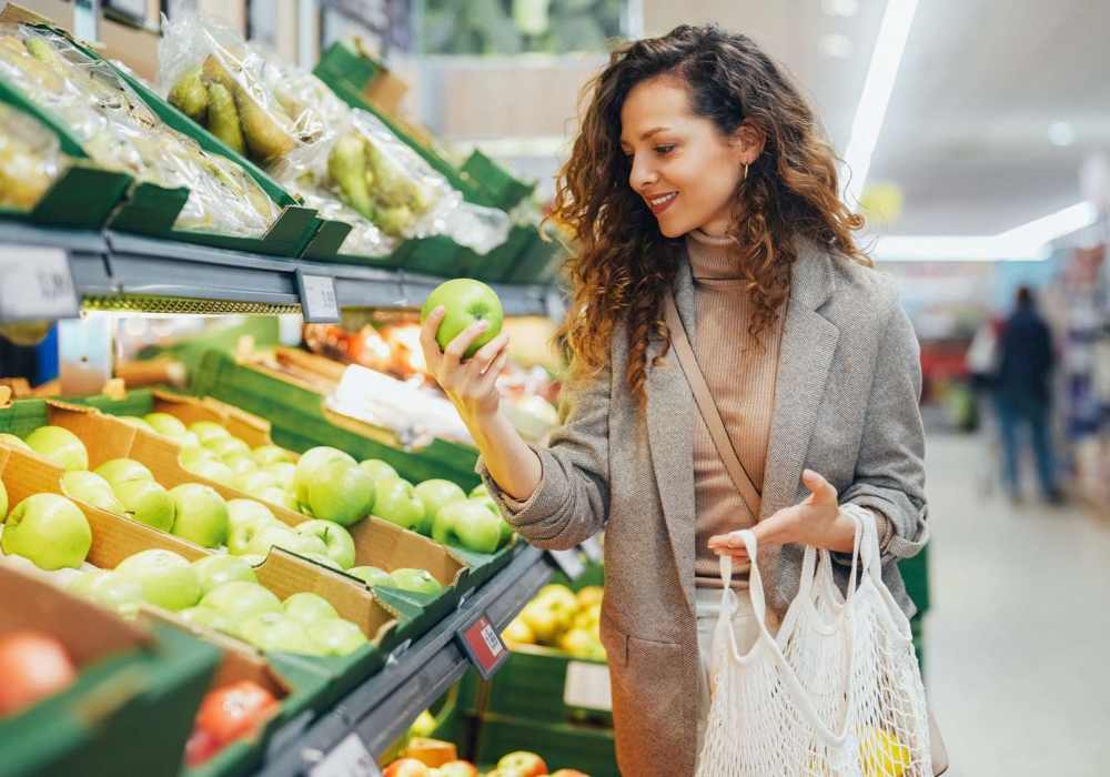 Resident picking up fresh vegetables at a store near Pacific Landing in Murrieta, California