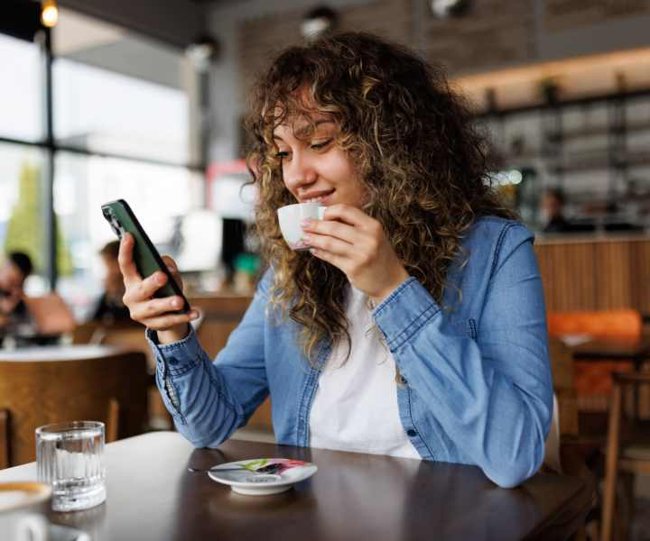 A resident drinking coffee in a shop near Ascent Apartment Homes in Asheville, North Carolina