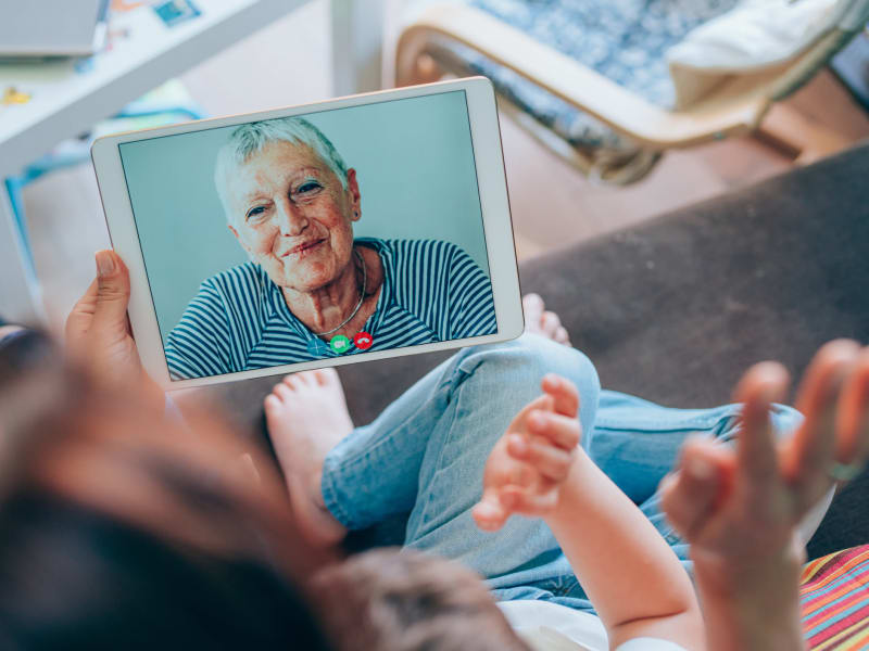 Family members talking to a resident though video at Compass Senior Living.