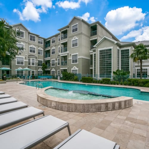 Poolside patio with lounge chairs at The Maroneal, Houston, Texas
