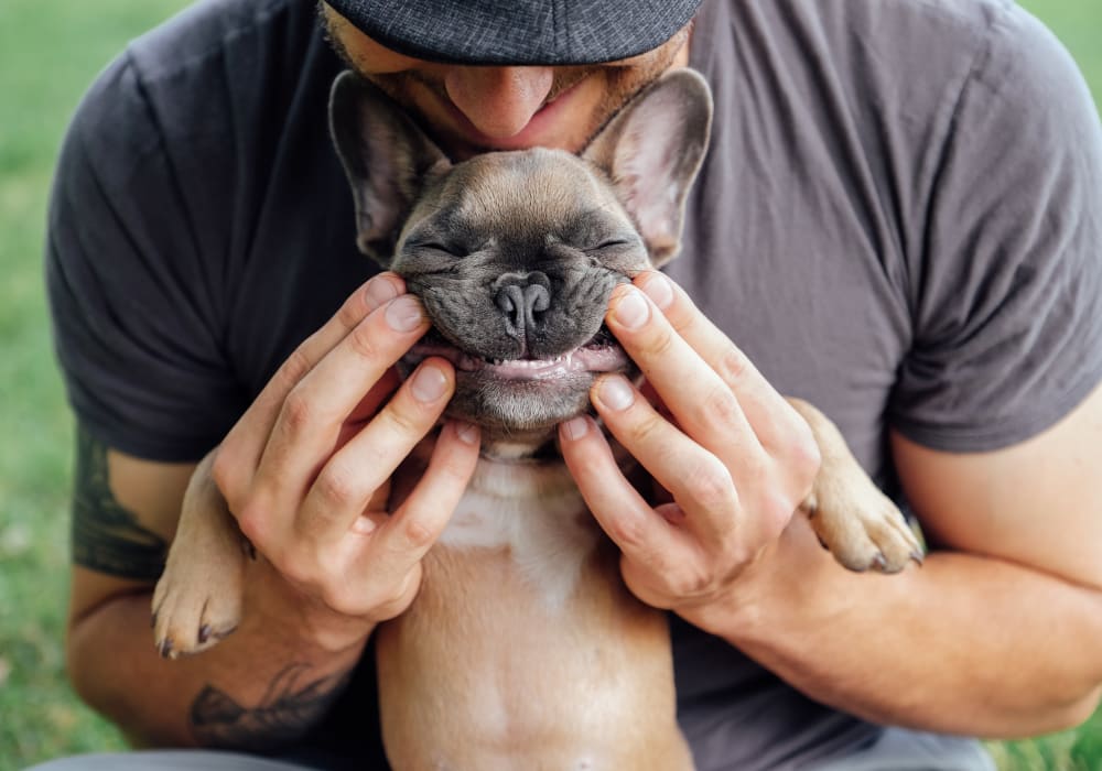 Resident and his pup posing for a photo at Sofi Sunnyvale in Sunnyvale, California