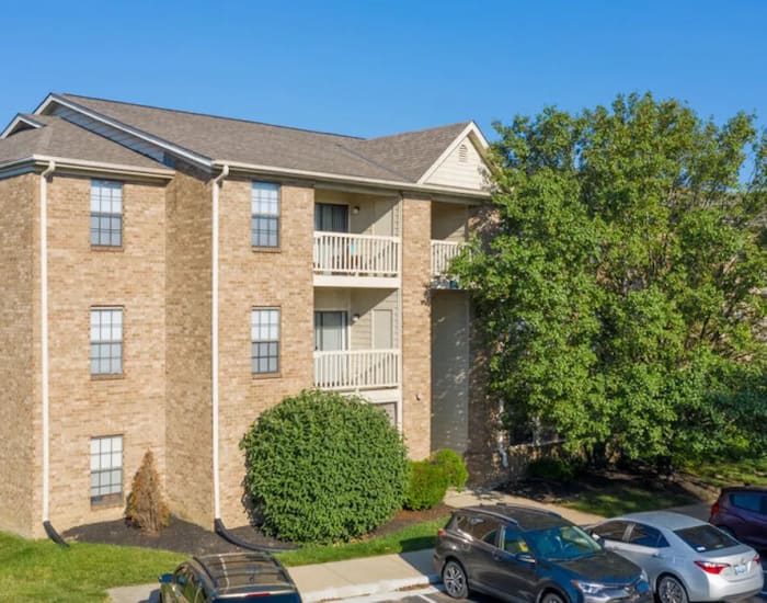 Exterior shot of the apartments with car parking space at Woodspring Apartments in Florence, Kentucky