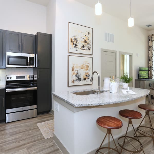 Kitchen with a breakfast bar at The District at Windy Hill in Atlanta, Georgia