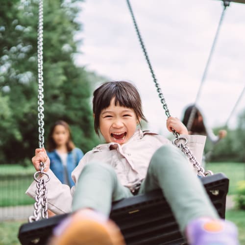 A child on the swings at Limestone Trail in Lebanon, Tennessee