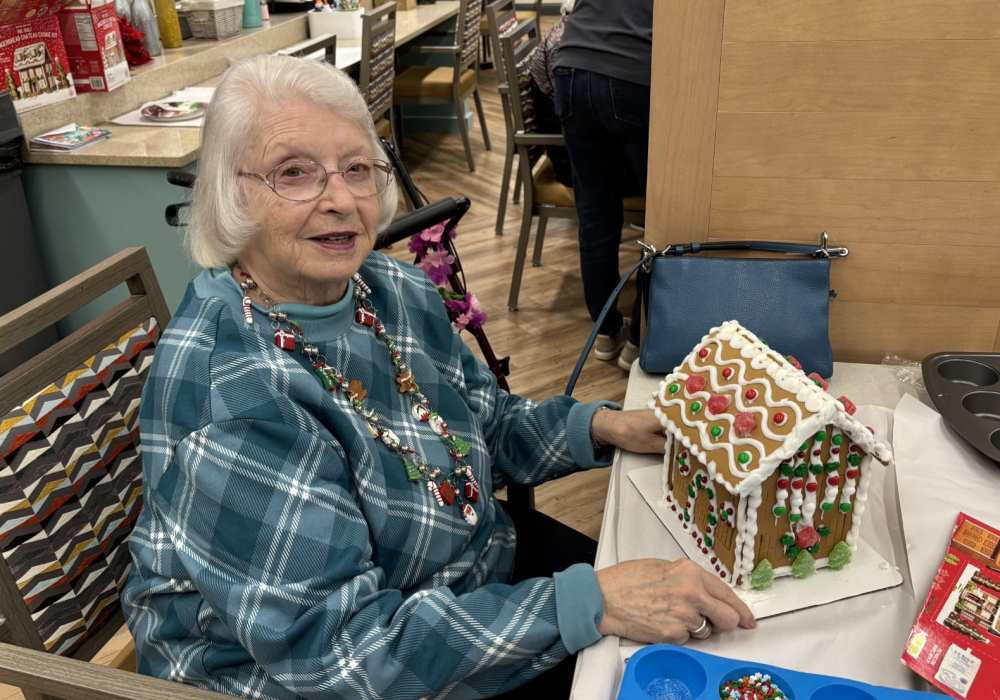 Resident with a miniature house at Merrill Gardens at Wright Park in Tacoma, Washington
