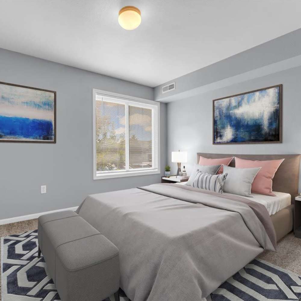 Primary bedroom with large windows at River Club in Holland, Michigan