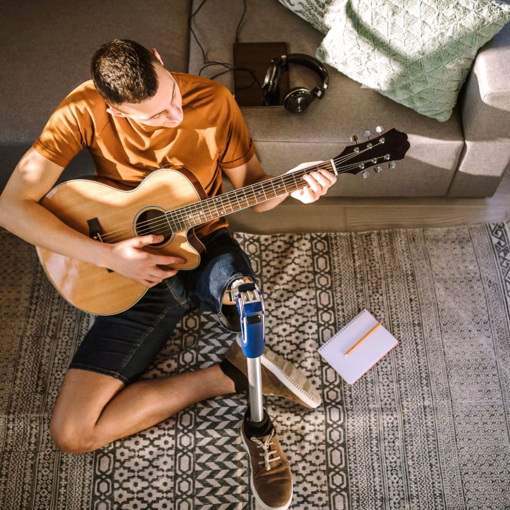 A resident plays his guitar in his apartment at Highland Hills, Cumberland, Rhode Island