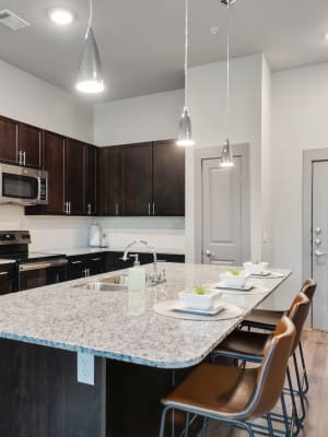 Gourmet kitchen with island seating at Discovery Park in Denton, Texas