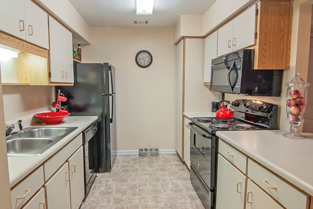 Kitchen with updated countertops and modern appliances at Greenleaf Apartments in Phenix City, Alabama