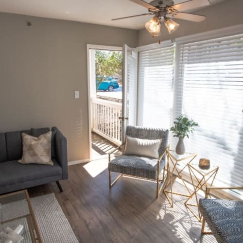 Apartment living room with a door out to a private patio at Webb Bridge Crossing in Alpharetta, Georgia