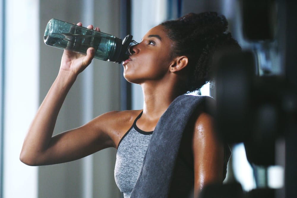 A resident drinking water after working out in the fitness center at Enclave at Woodcrest Station in Cherry Hill, New Jersey