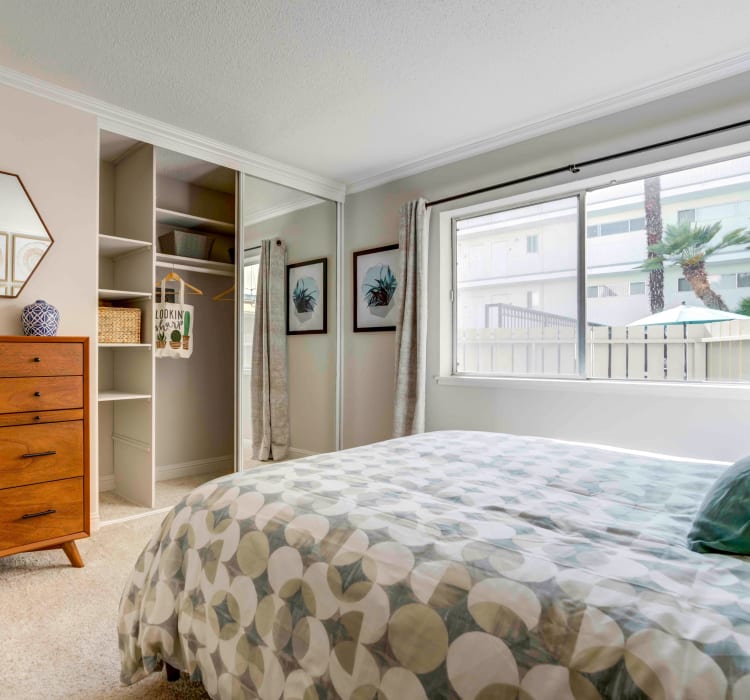 Master bedroom with plush carpeting and an en suite bathroom in a model home at Sofi Redwood Park in Redwood City, California