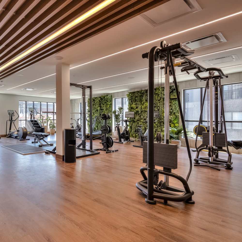 Spacious gym with modern equipment and green accents at Green|House Columbus in Columbus, Ohio
