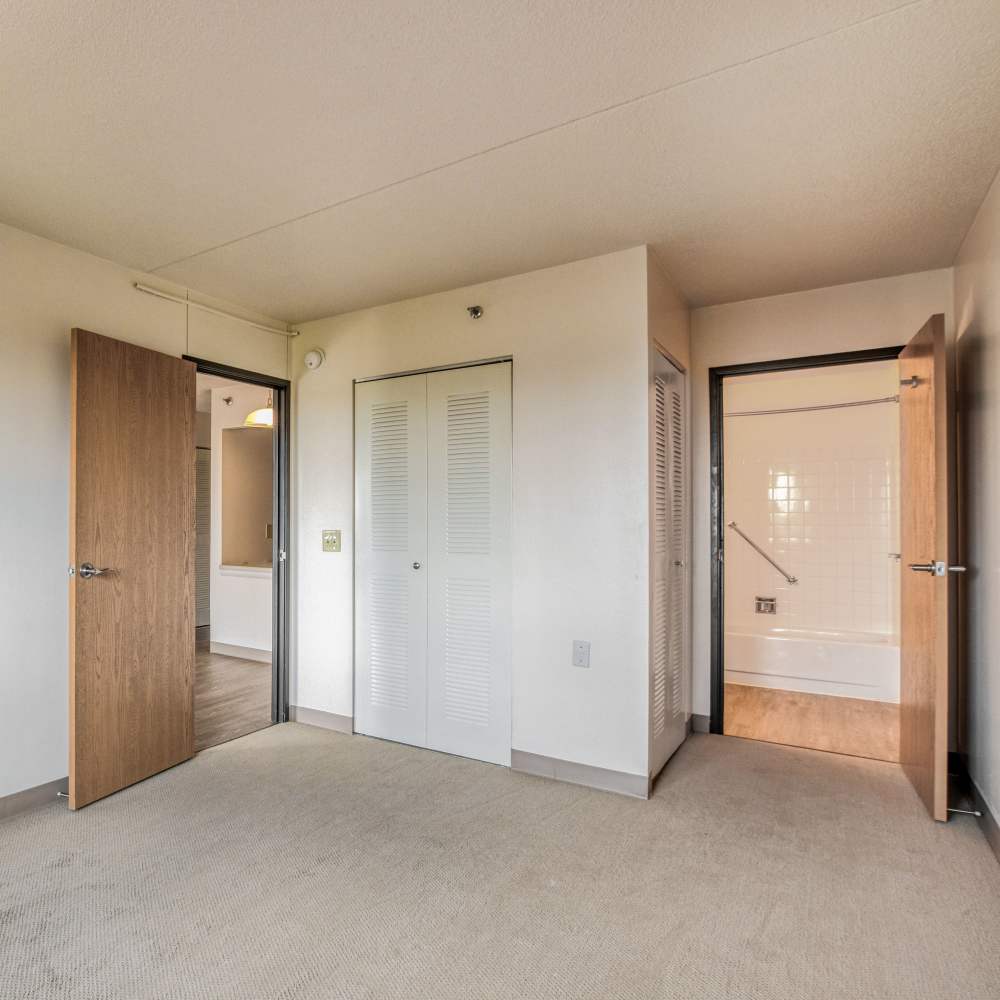 Unfurnished bedroom with access to bathroom at Village Center in Detroit, Michigan