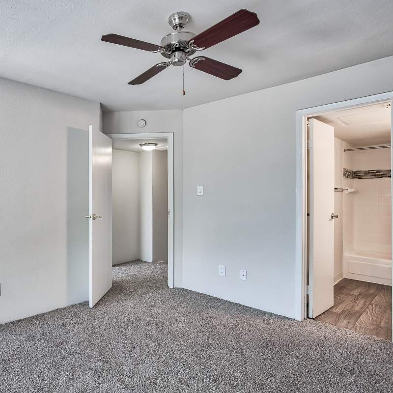 Bedroom with walk-in closets at Branch Creek Apartments in Carrollton, Texas