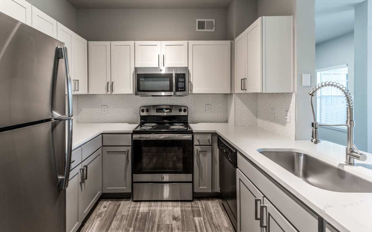 Modern apartment kitchen with stainless-steel appliances at Alexander in Spring, Texas