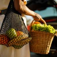 Resident carrying fresh groceries near River Club in Holland, Michigan