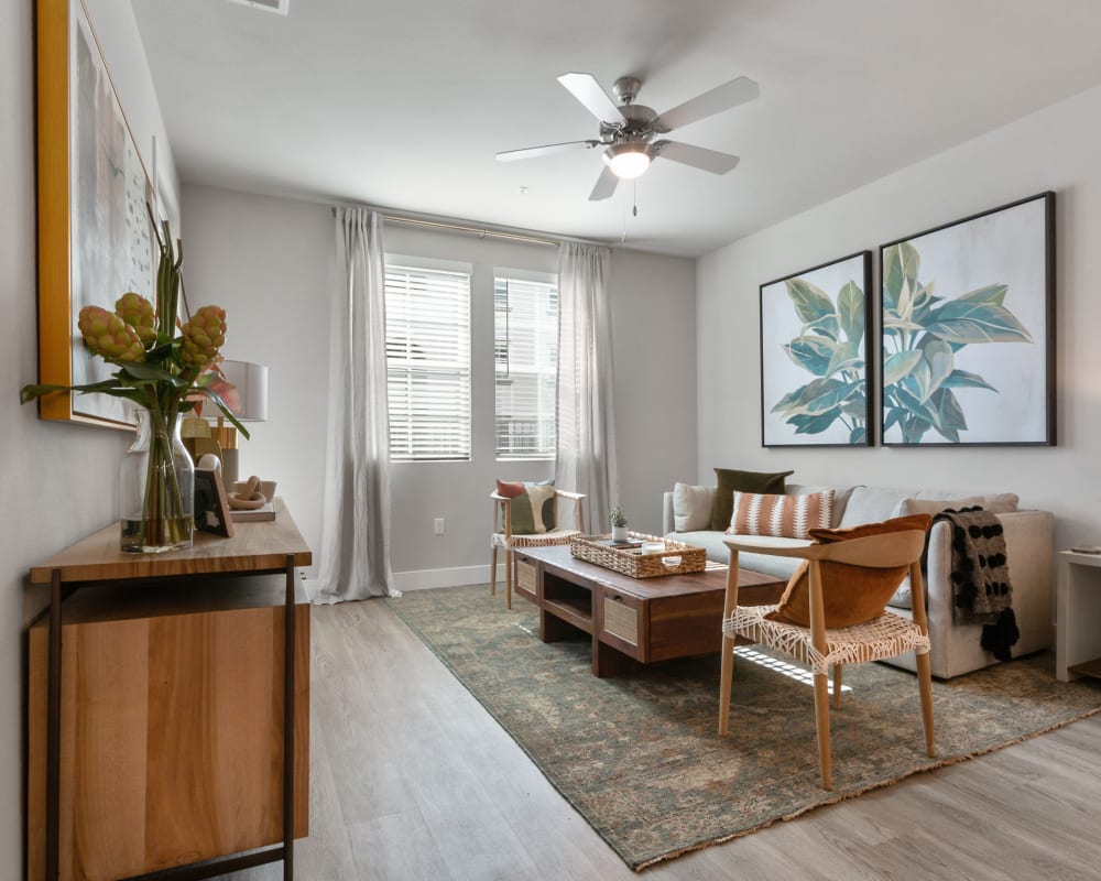 A furnished living room with wood flooring in a townhome at Alivia Townhomes in Whittier, California