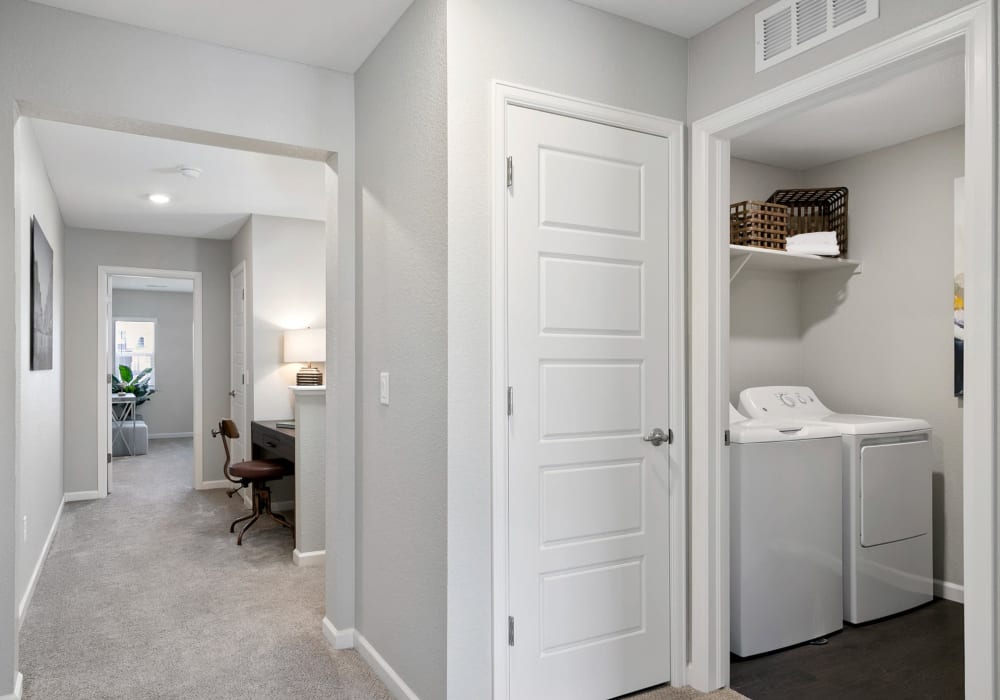 Big hallway with a washer and dryer at the end for easy laundry day at BB Living Light Farms in Celina, Texas