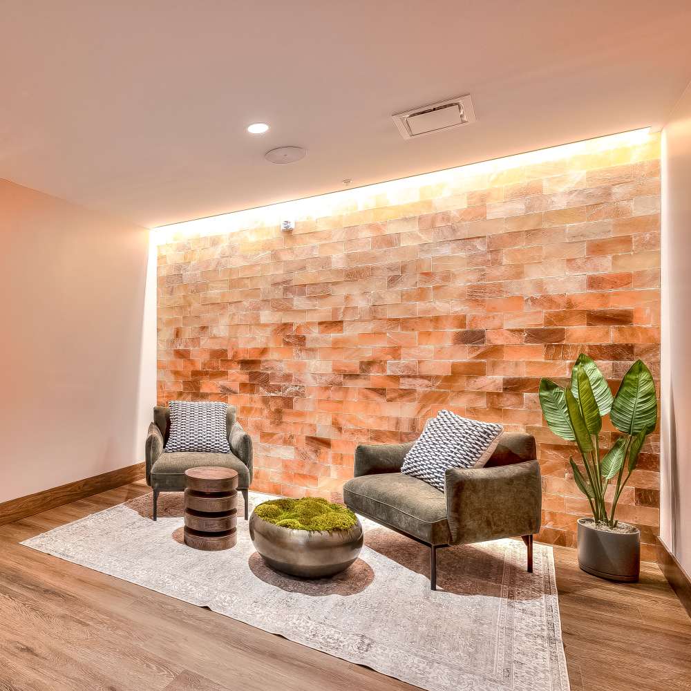 Inviting relaxation area with stylish chairs and salt wall accents at Green|House Columbus in Columbus, Ohio