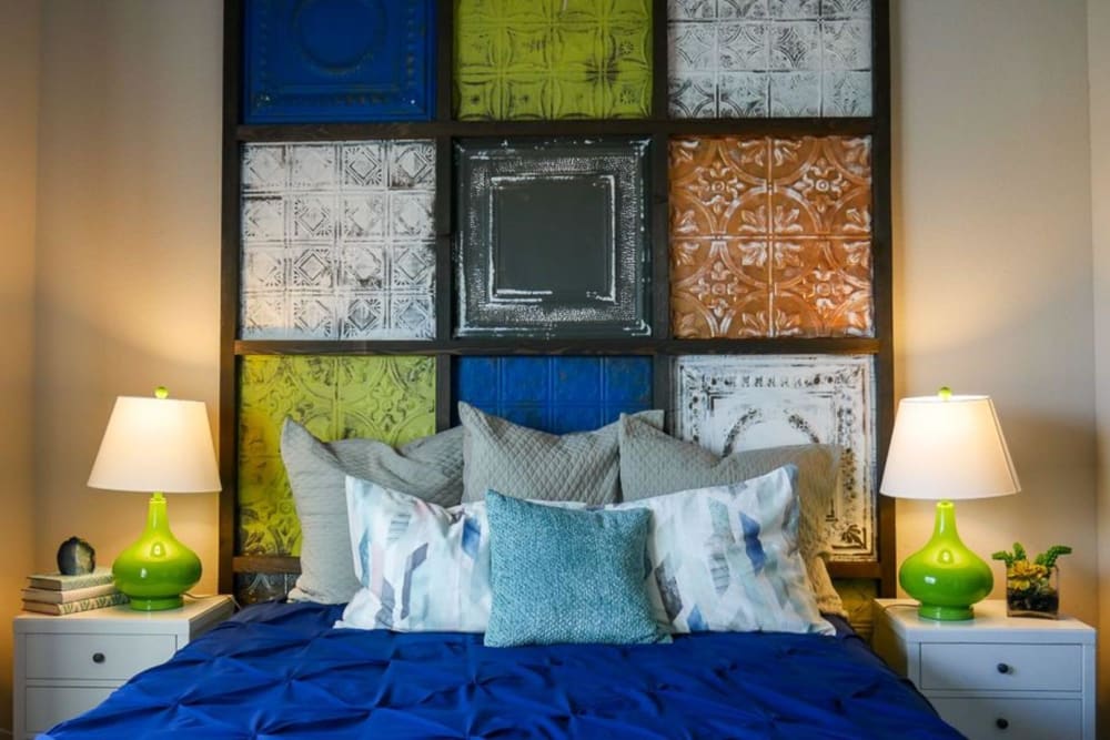 Model bedroom with colorful backboard at Biltmore at the Park in Pflugerville, Texas