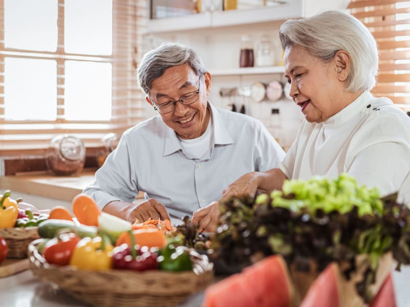 A couple cooking in their kitchen at Leisure Living Lakeside in Evansville, Indiana