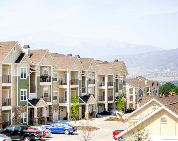 Apartment buildings and mountains view at Peaks at Woodmen Apartments in Colorado Springs, Colorado