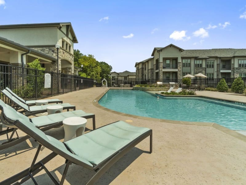 Lounge chairs and sparkling pool at Auberge of Tyler in Tyler, Texas