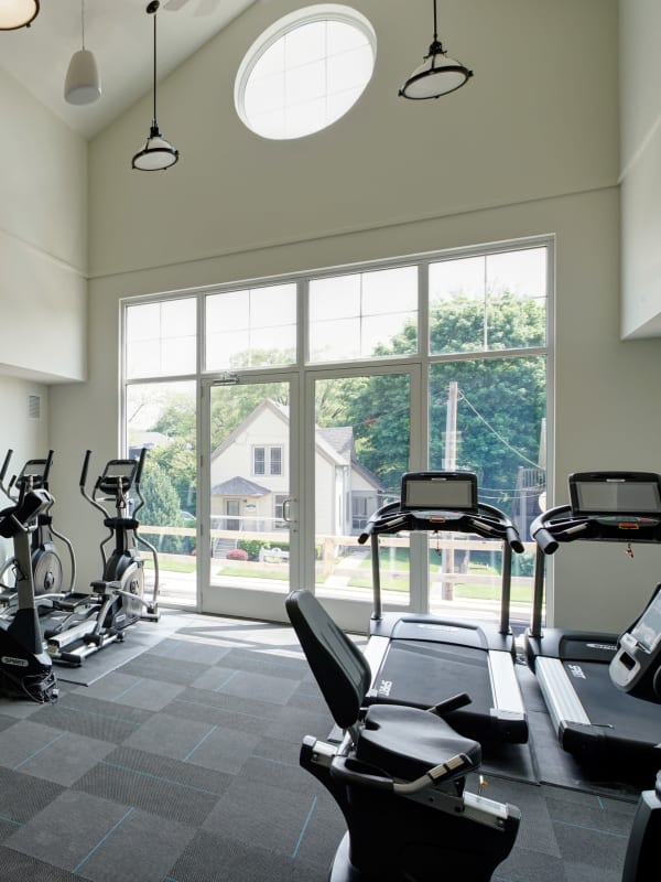 Community fitness room at with various forms of cardio equipment at Courthouse Square Apartments in Wheaton, Illinois