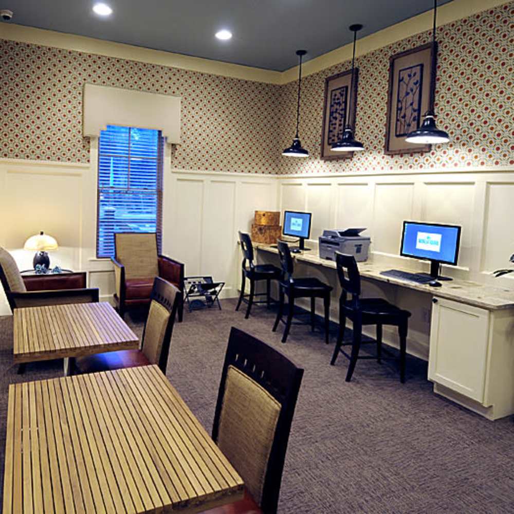 Modern workspace featuring stylish wooden tables, comfortable seating, and contemporary computers in a beautifully designed setting at Avonlea Square in Smyrna, Georgia.